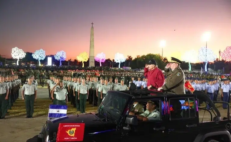 Dictator Daniel Ortega (in red jacket) and General Julio César Avilés “review” troops.