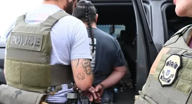 Two Immigration and Customs Enforcement (ICE) agents arrest an immigrant in Denver